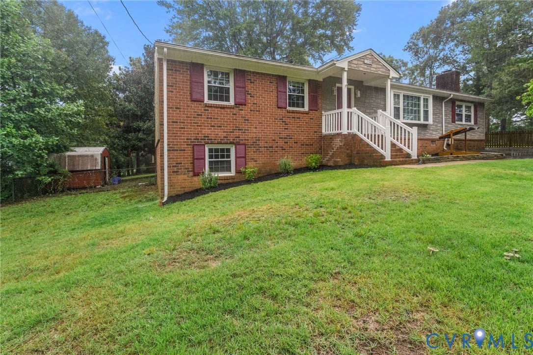 Brick and siding exterior with white railing porch