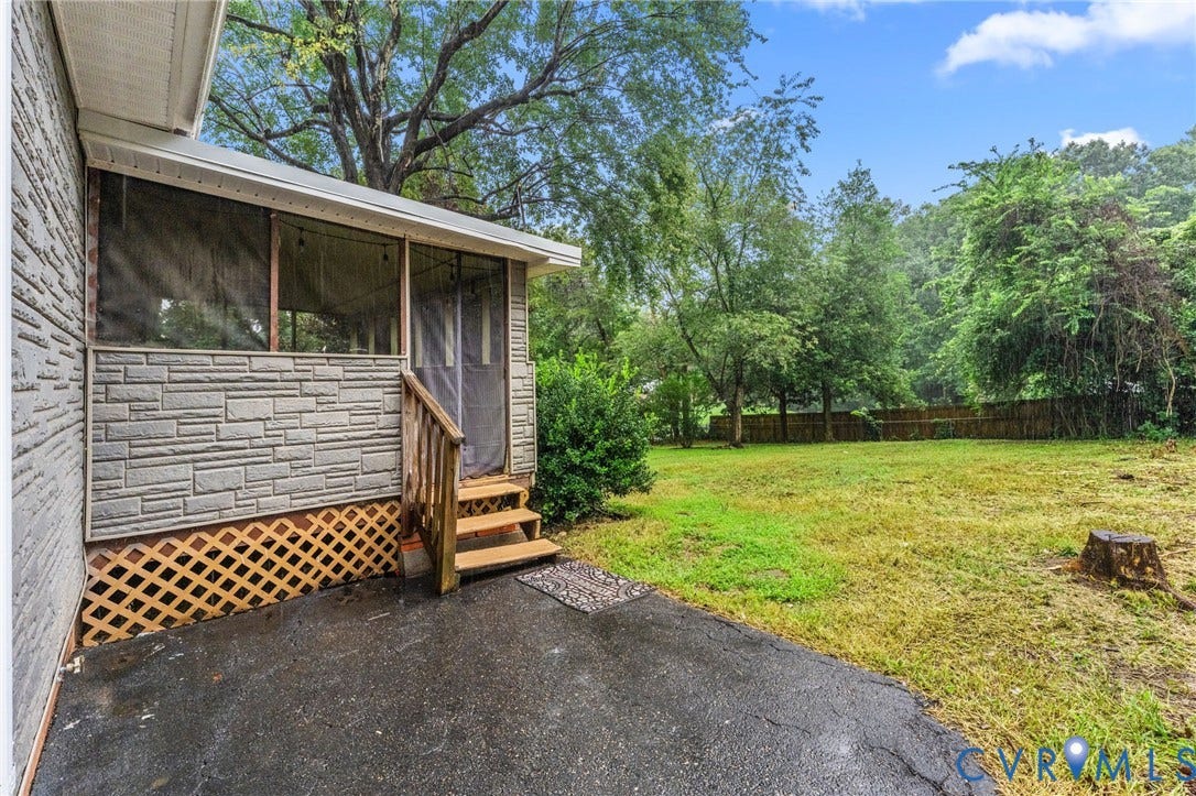 Screened porch with wood steps and railing