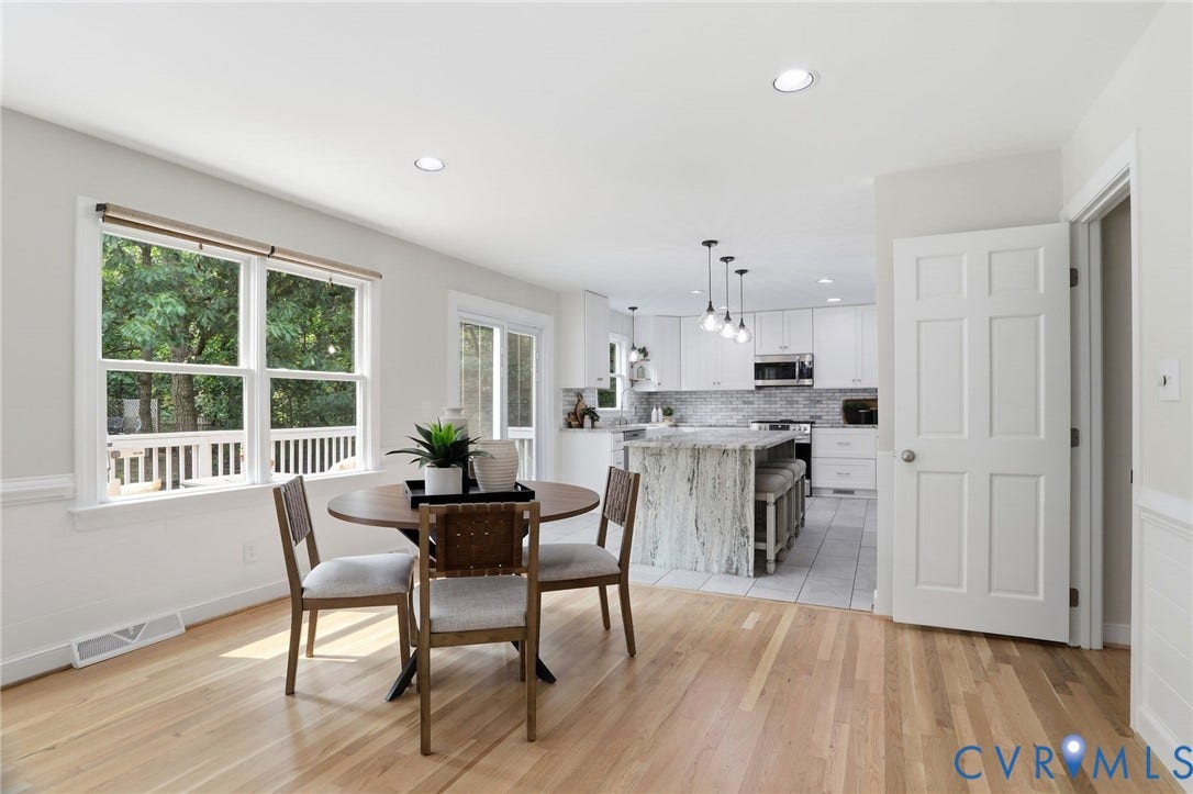 2904 Old Gun Rd W, Old Gun, Midlothian, VA 23113 Open-concept dining area featuring wood-finish flooring, recessed lighting, and a double window with exterior railing