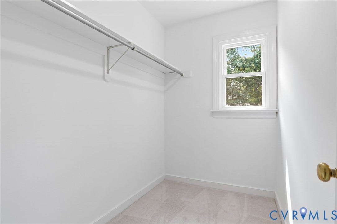 2904 Old Gun Rd W, Old Gun, Midlothian, VA 23113 Spacious closet featuring a window, light-toned carpeting, white walls, and a metal hanging rod