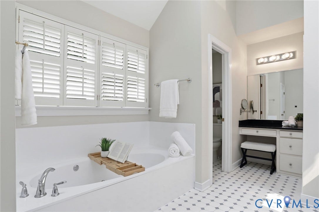 2904 Old Gun Rd W, Old Gun, Midlothian, VA 23113 White soaking tub with polished chrome fixtures and plantation shutters
