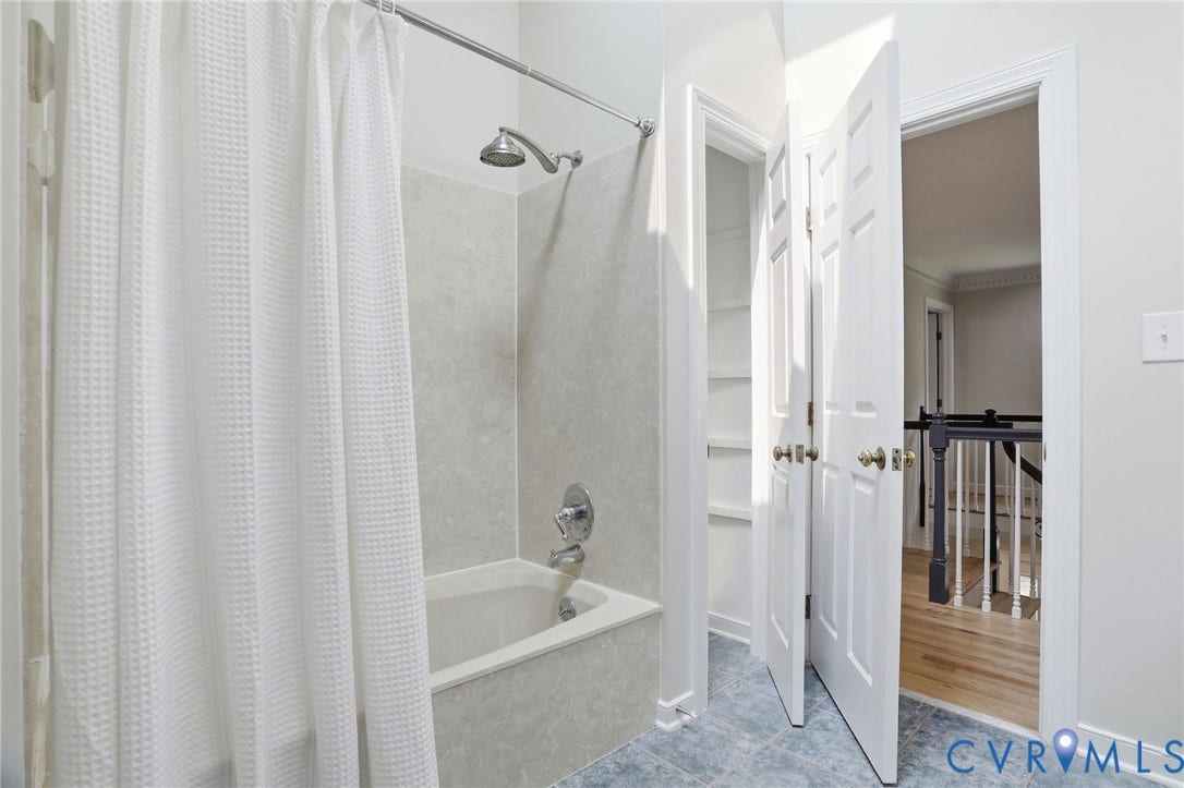 2904 Old Gun Rd W, Old Gun, Midlothian, VA 23113 Full bathtub with shower fixture, tiled surround, and chrome hardware