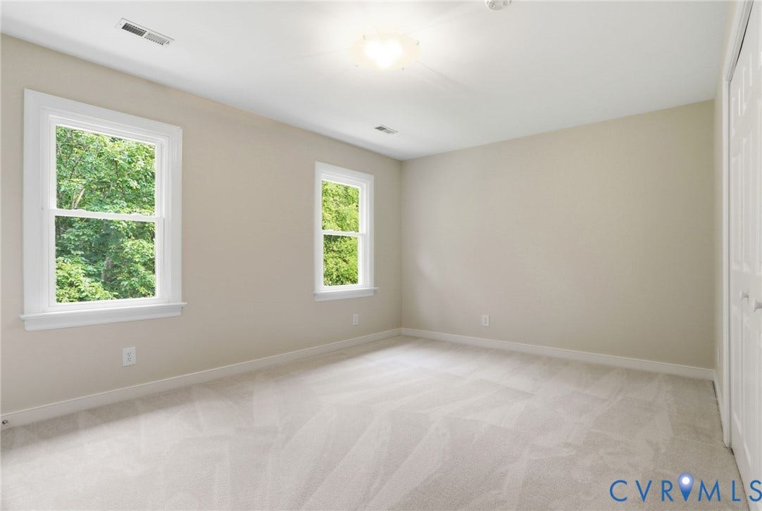 2904 Old Gun Rd W, Old Gun, Midlothian, VA 23113 Carpeted interior room with neutral-toned walls, two double-hung windows, and a flush mount ceiling light fixture
