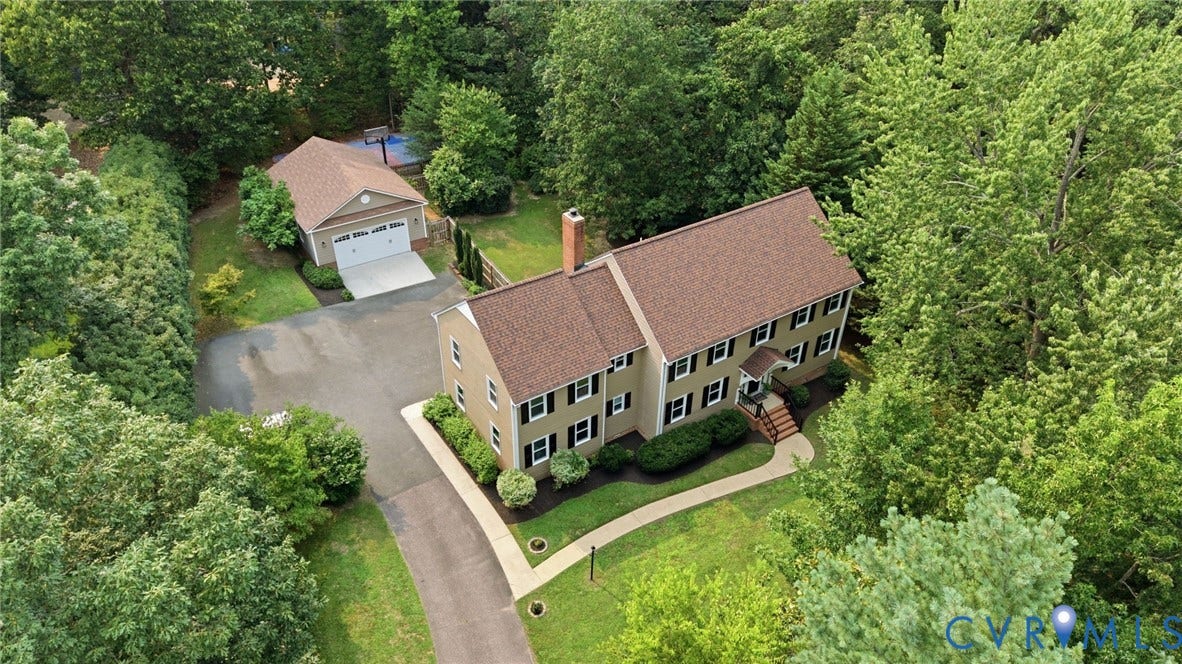 2904 Old Gun Rd W, Old Gun, Midlothian, VA 23113 Colonial-style residence featuring a prominent front entrance, multiple windows with dark shutters, and a brick chimney