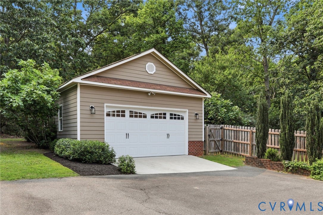 2904 Old Gun Rd W, Old Gun, Midlothian, VA 23113 Detached two-car garage with panel siding, brick accents, and a white overhead door