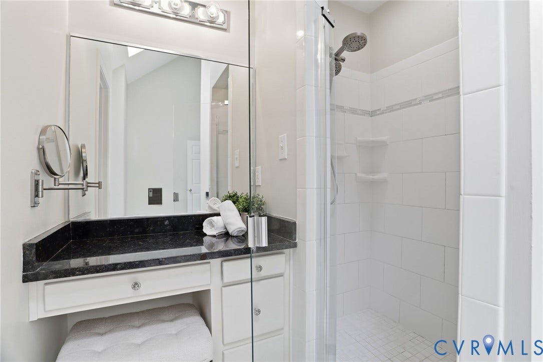 2904 Old Gun Rd W, Old Gun, Midlothian, VA 23113 Vanity with a dark stone countertop, a large mirror, and a wall-mounted cosmetic mirror