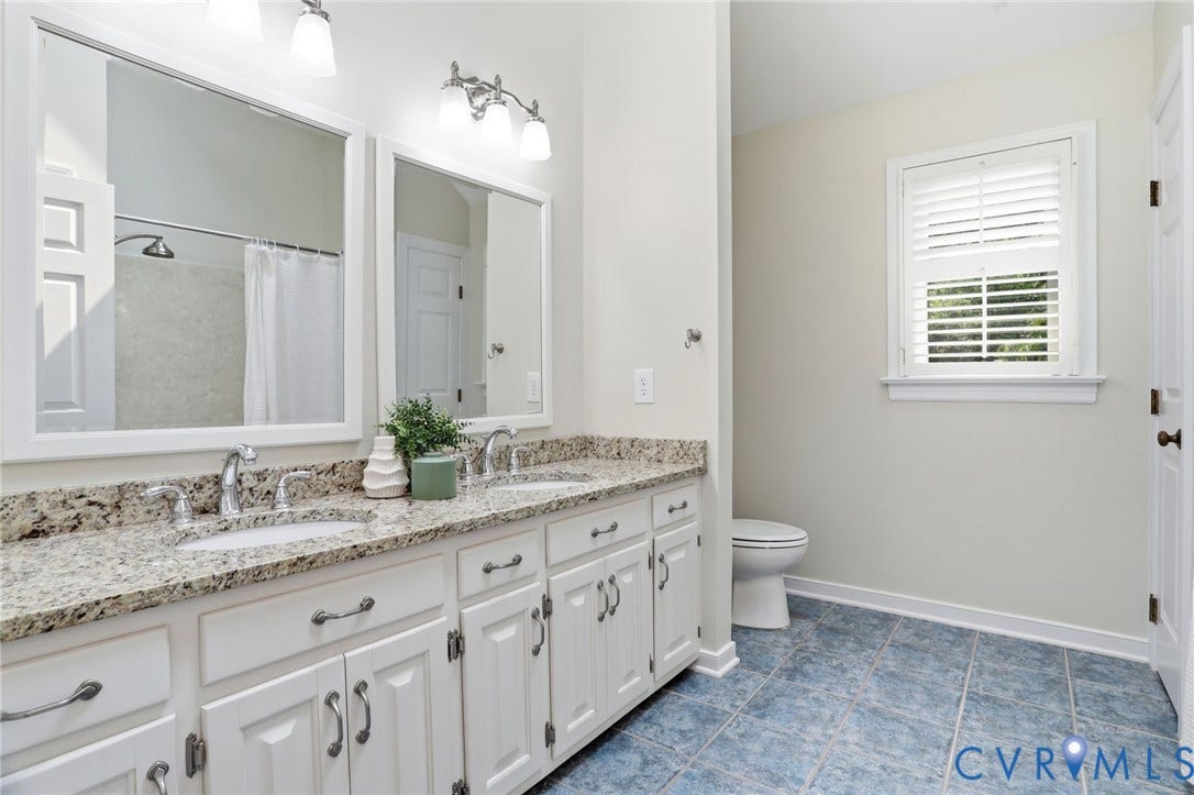 2904 Old Gun Rd W, Old Gun, Midlothian, VA 23113 Dual vanity with an extended countertop, white cabinetry, undermount sinks, and chrome faucets