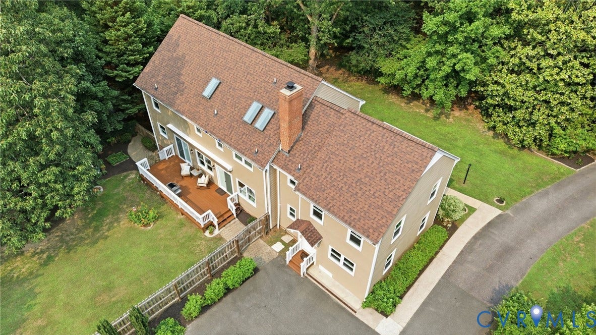 2904 Old Gun Rd W, Old Gun, Midlothian, VA 23113 Two-story residence featuring a shingle roof with skylights, multiple windows, and a prominent brick chimney