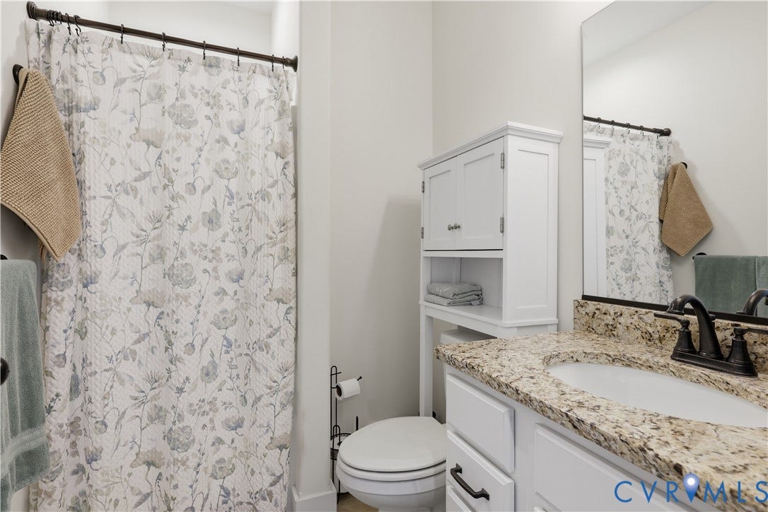 25181 W Soap Stone Rd, Amelia, VA 23083 Bathroom featuring a vanity with a granite-style countertop, white cabinetry, undermount sink, and dark bronze-tone faucet