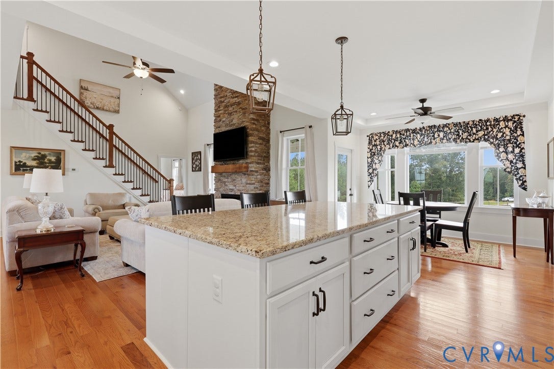 25181 W Soap Stone Rd, Amelia, VA 23083 Open-concept living space featuring a large kitchen island with light-toned granite countertop and white cabinetry