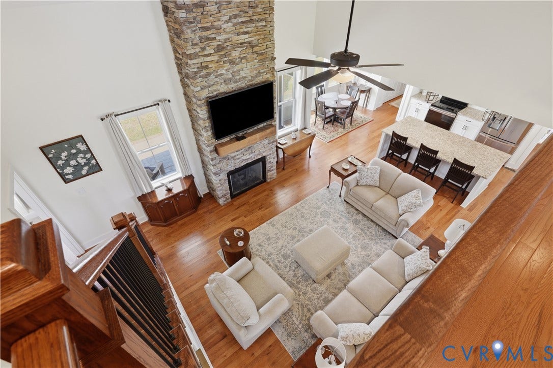 25181 W Soap Stone Rd, Amelia, VA 23083 Open-concept living area featuring a vaulted ceiling and wood-finish flooring