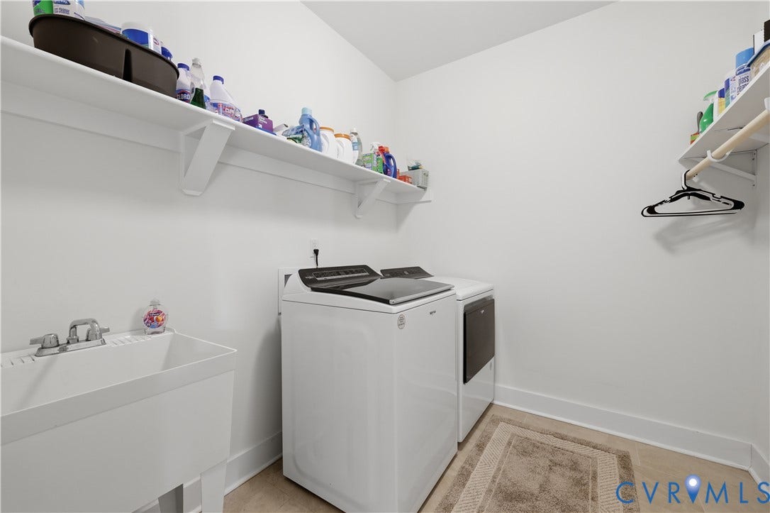 25181 W Soap Stone Rd, Amelia, VA 23083 Dedicated utility space featuring a utility sink with dual-handle faucet, expansive shelving, and a hanging rod