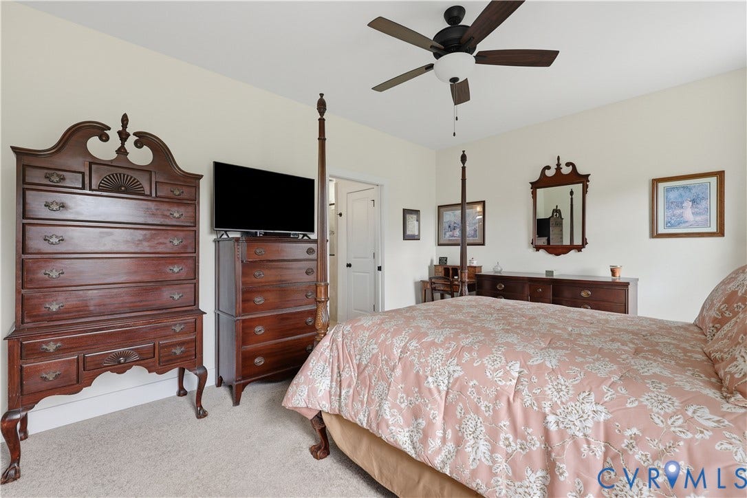 25181 W Soap Stone Rd, Amelia, VA 23083 Carpeted bedroom featuring neutral wall paint, a ceiling fan with integrated lighting, and white trim