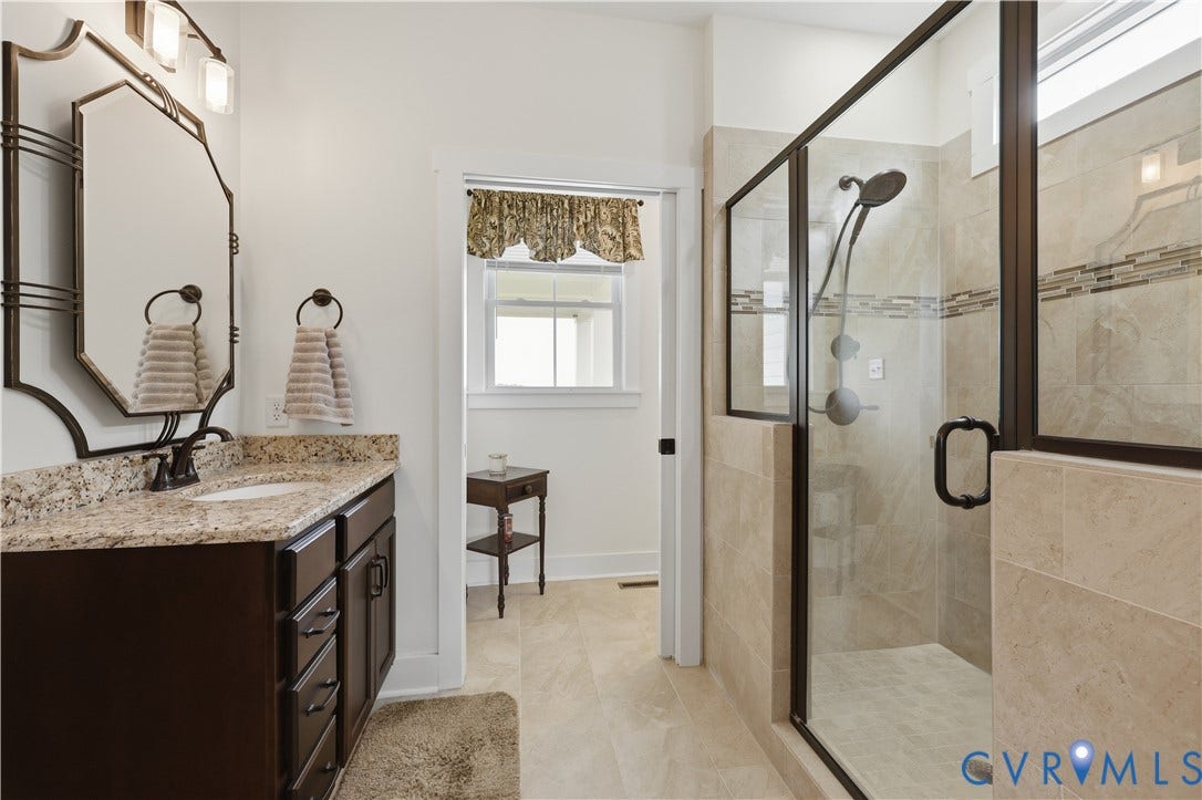 25181 W Soap Stone Rd, Amelia, VA 23083 Bathroom featuring a dark wood vanity with a granite countertop, a rectangular undermount sink, and an ornate framed mirror