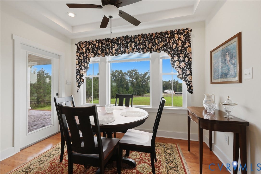 25181 W Soap Stone Rd, Amelia, VA 23083 Dining space featuring wood-finish flooring, a tray ceiling with recessed lighting, and a ceiling fan