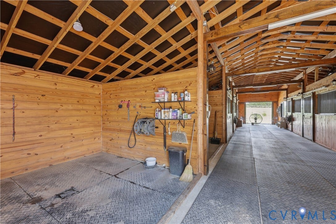 25181 W Soap Stone Rd, Amelia, VA 23083 Barn interior featuring wood plank walls and exposed wood beam ceiling