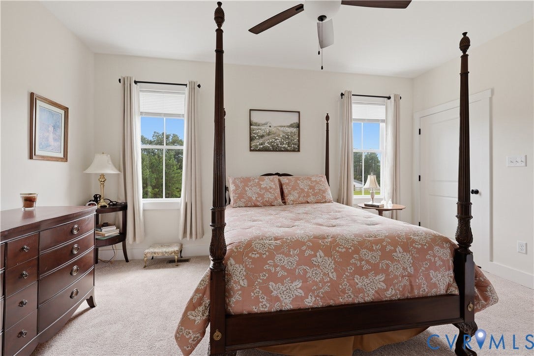 25181 W Soap Stone Rd, Amelia, VA 23083 Bright room featuring neutral wall paint, carpet flooring, a ceiling fan, and two windows