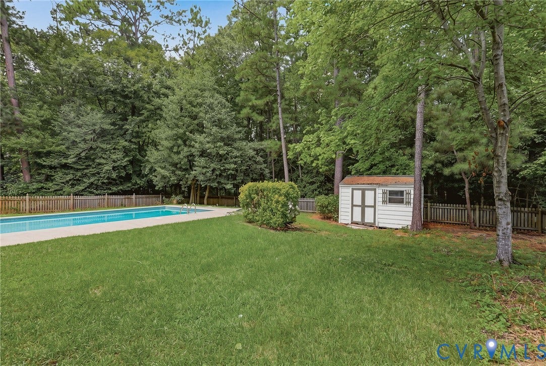 Expansive backyard featuring an in-ground pool, detached storage shed, and plenty of space for entertaining and outdoor enjoyment.
