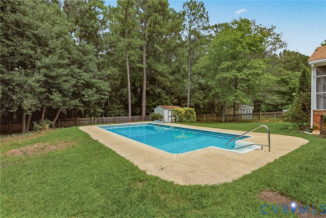Expansive backyard featuring an in-ground pool, detached storage shed, and plenty of space for entertaining and outdoor enjoyment.