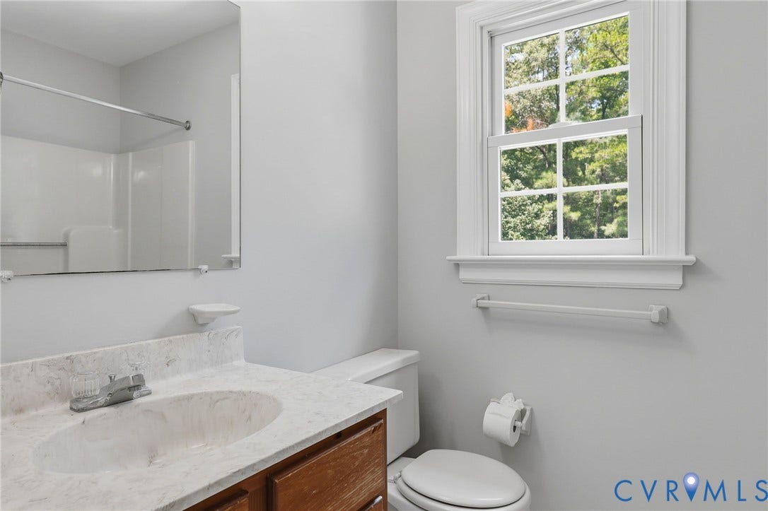 Spacious primary bath featuring fresh paint, a soaking tub, and a separate shower