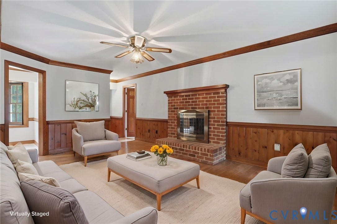 Virtually staged family room with gas fireplace, hardwood floors and crown molding.