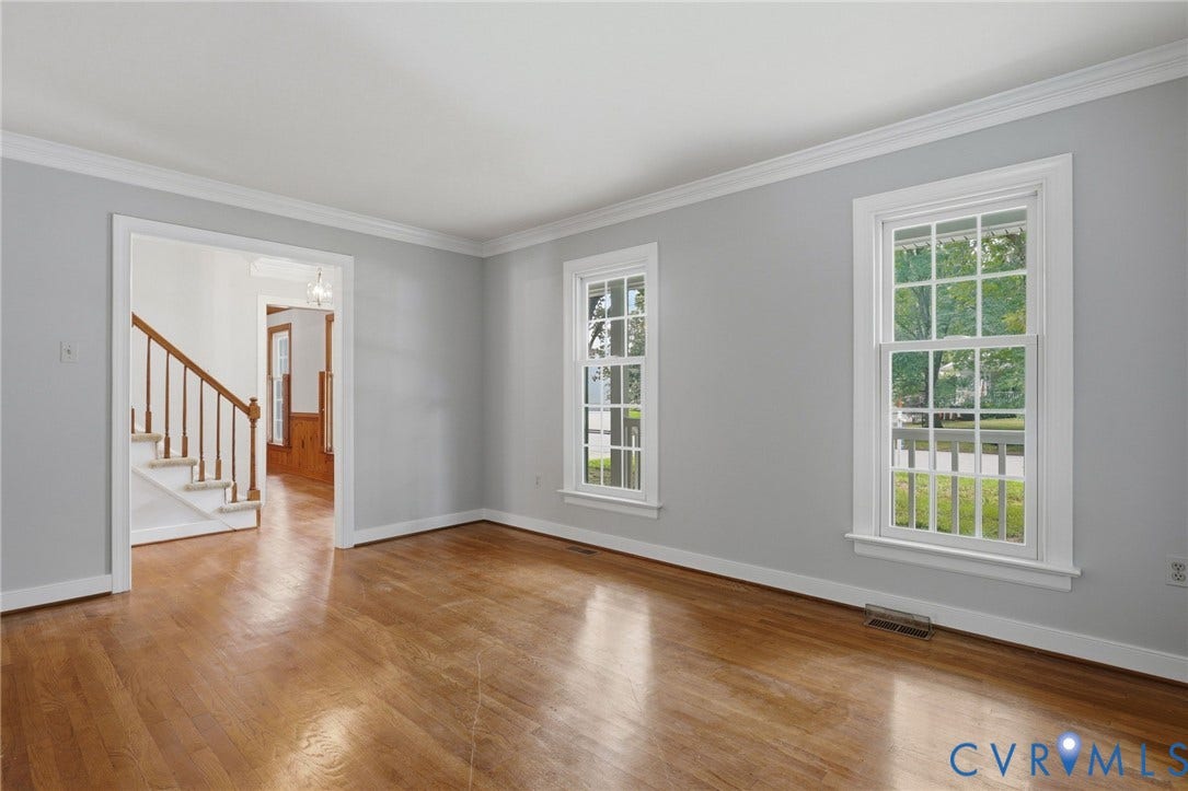 Alternative view of living room that opens to entry forer and dining room