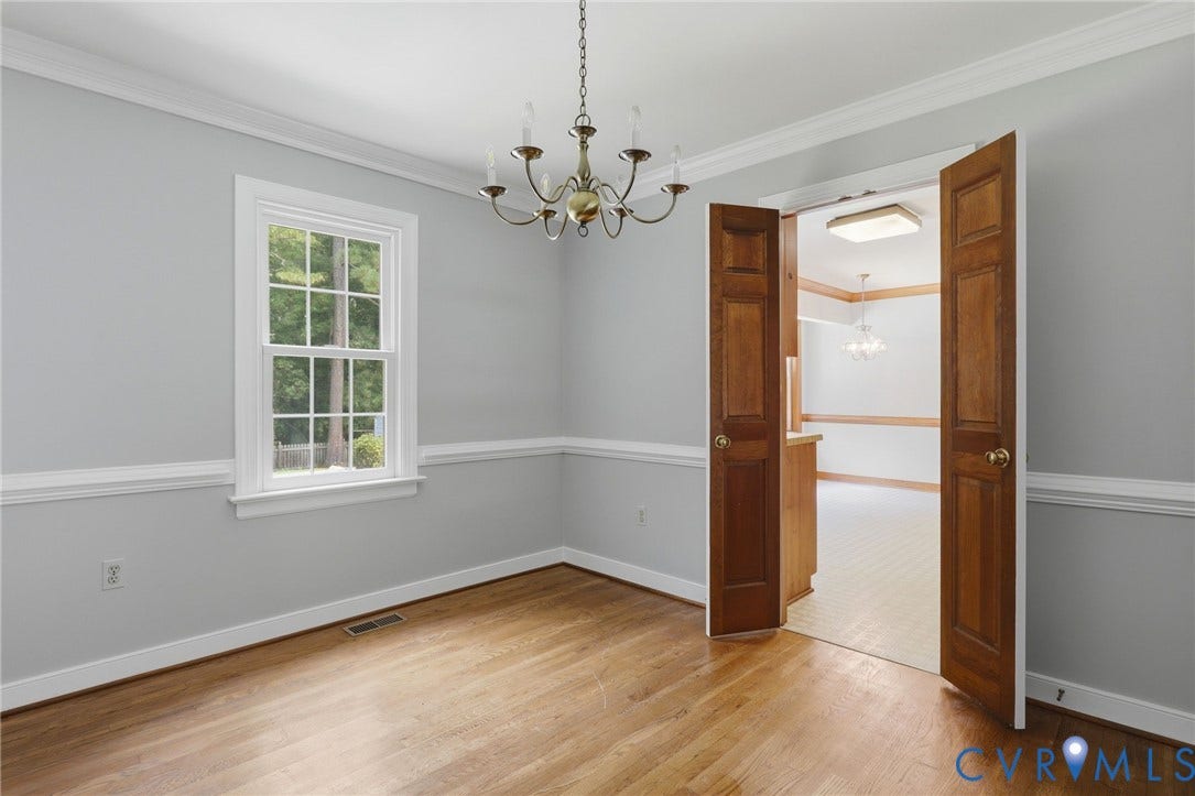Alternative view of dining room with hardwood flooring, fresh interior paint, crown molding, and French doors leading to the kitchen