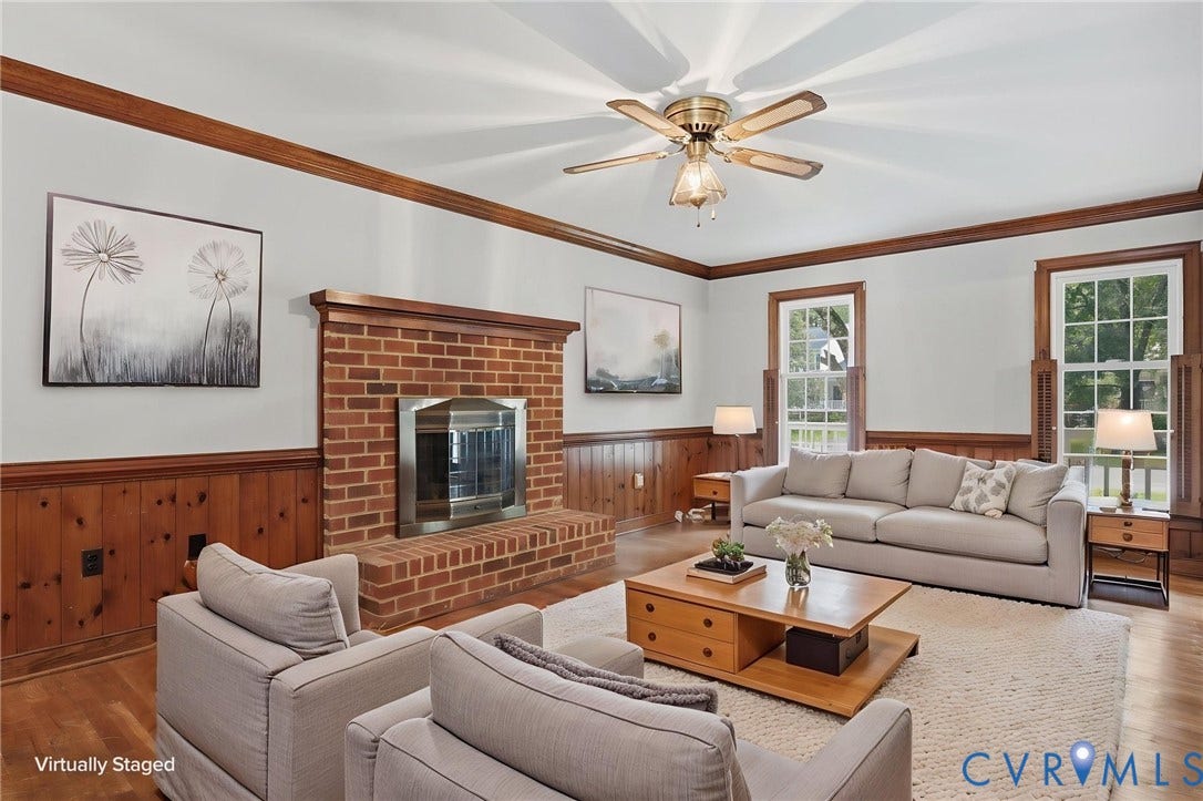 Virtually staged family room with gas fireplace, hardwood floors and crown molding.