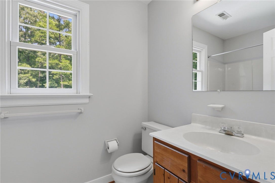 Upstairs guest bath with fresh neutral paint, a tub/shower combination, and natural light overlooking the backyard pool