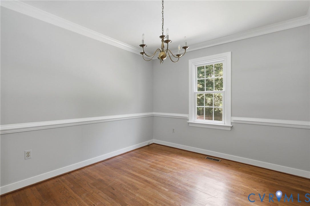 Dining room features hardwood floors, crown molding, chair rail and fresly painted.