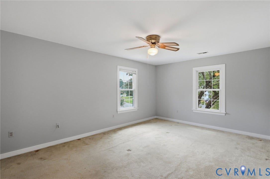 Spacious primary suite featuring fresh paint, a large closet, and a private en-suite bath