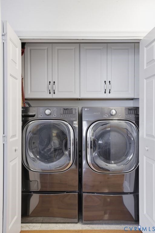 9437 Willow Ridge Drive, Glen Allen, VA 23060 Built-in laundry closet with bi-fold doors, upper cabinetry, and a full-size washer and dryer