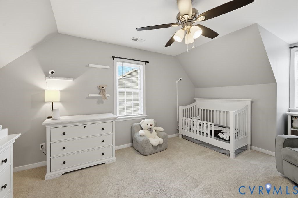 9437 Willow Ridge Drive, Glen Allen, VA 23060 Vaulted ceilings with a ceiling fan, window with black trim, and light-colored carpet