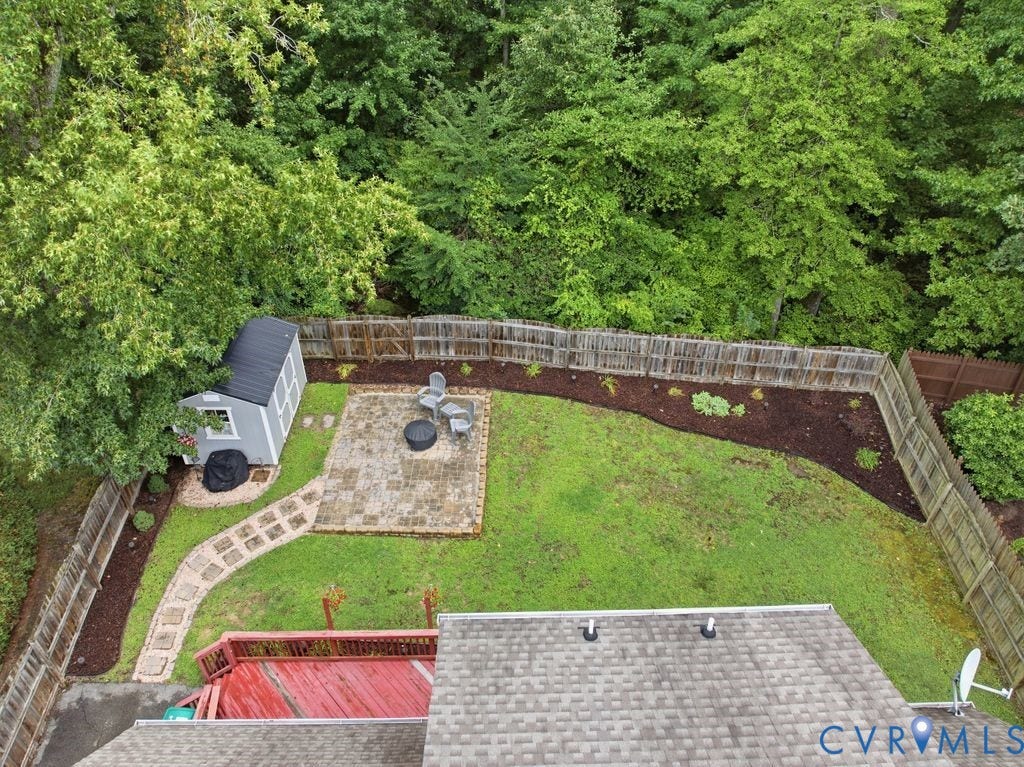 9437 Willow Ridge Drive, Glen Allen, VA 23060 Fenced backyard featuring a paved patio, stone-paved walkway, and a storage shed