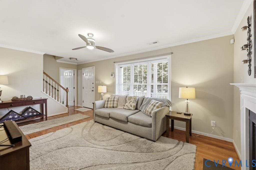 9437 Willow Ridge Drive, Glen Allen, VA 23060 Hardwood flooring, crown molding, double pane windows, ceiling fan, and a fireplace with a white mantel