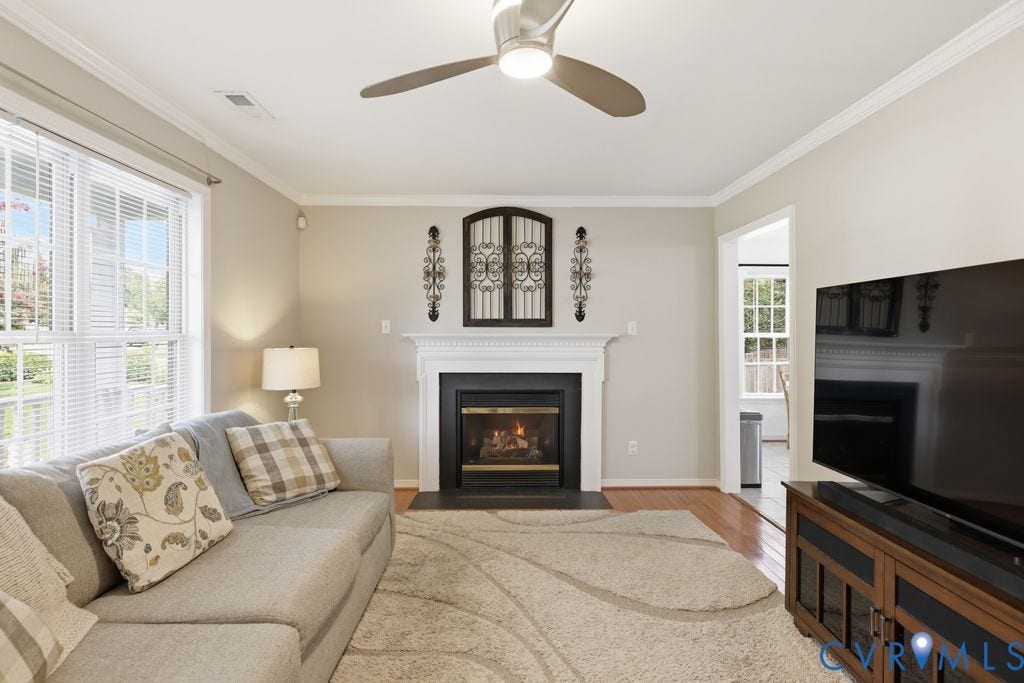 9437 Willow Ridge Drive, Glen Allen, VA 23060 Fireplace with a classic white mantel, wood-finish flooring, ceiling fan with integrated lighting, recessed lighting, and crown molding