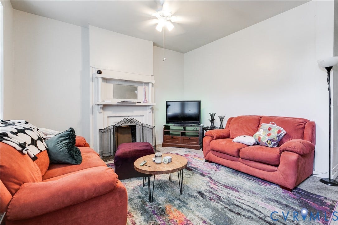 204 Welford Street, Barton Heights, Richmond, VA 23222 Living room featuring a decorative mantelpiece, ceiling fan, and white walls
