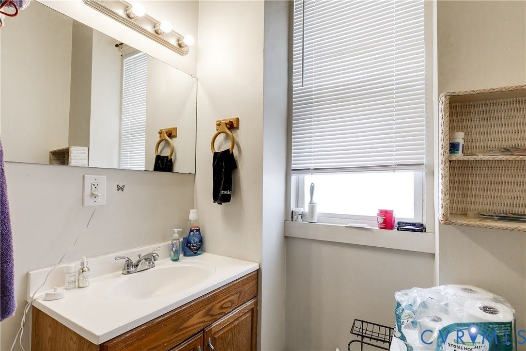 204 Welford Street, Barton Heights, Richmond, VA 23222 Bathroom featuring a vanity with a white countertop and wood-finish cabinetry, illuminated by a four-bulb vanity light fixture