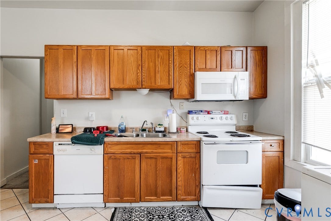 204 Welford Street, Barton Heights, Richmond, VA 23222 Kitchen featuring wood cabinetry, white appliances, a built-in microwave, and tile flooring