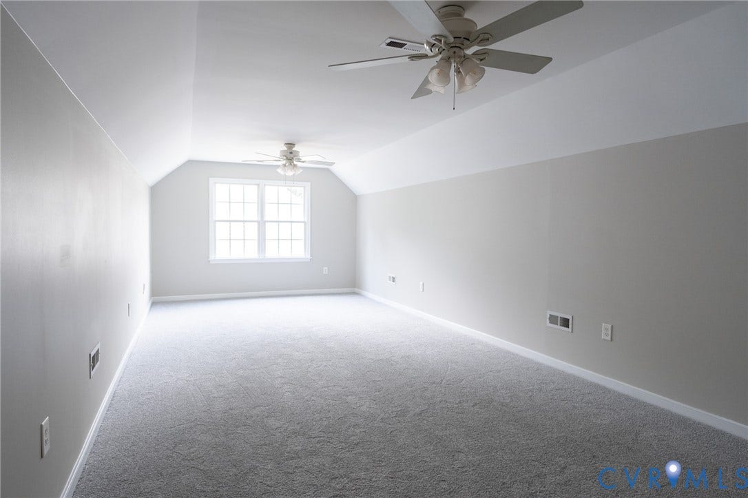 4805 Saddleridge Court, Saddleridge At Twin Hickory, Glen Allen, VA 23059 Third floor spacious room featuring vaulted ceilings, a prominent window with grid panes, plush grey carpeting, and two ceiling fans with light fixtures