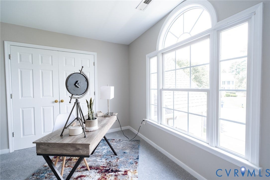 4805 Saddleridge Court, Saddleridge At Twin Hickory, Glen Allen, VA 23059 Bedroom featuring a large arched window with grid patterns, light gray wall paint, white trim, and light gray carpeting