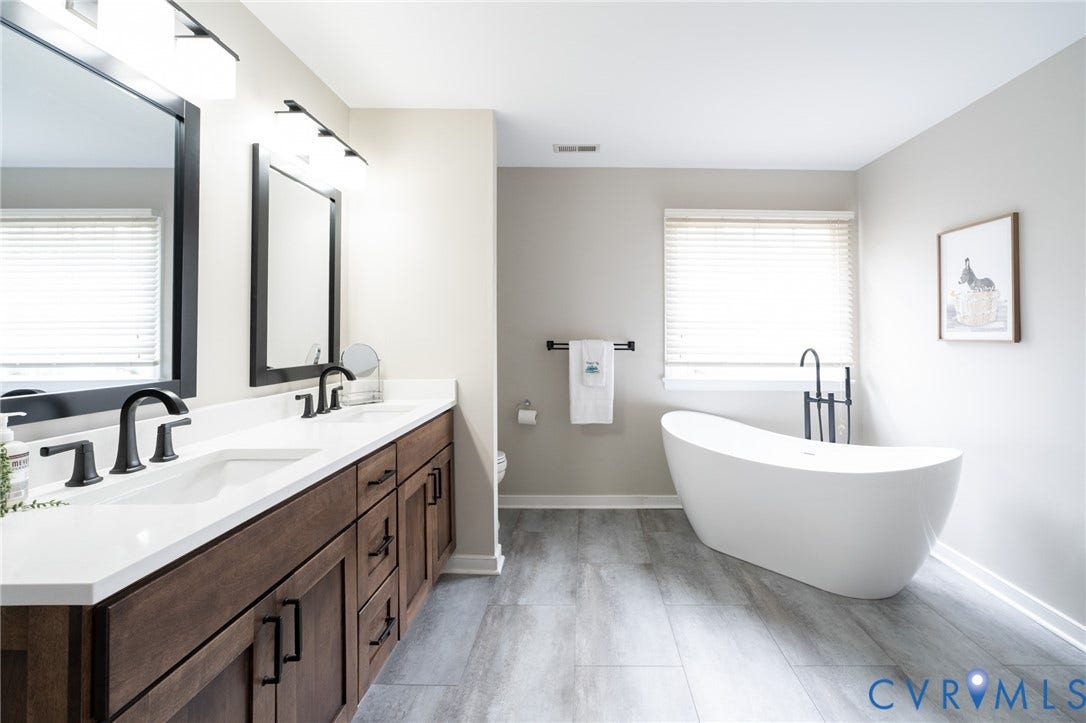 4805 Saddleridge Court, Saddleridge At Twin Hickory, Glen Allen, VA 23059 Primary bathroom featuring a freestanding tub, dual vanity with solid surface countertop, matte black fixtures, and tiled flooring