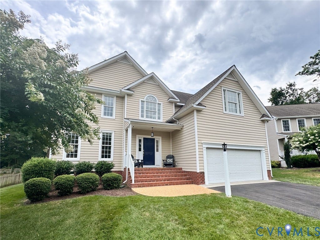 4805 Saddleridge Court, Saddleridge At Twin Hickory, Glen Allen, VA 23059 Traditional two-story residence featuring light-toned siding, a deep blue front door, and a two-car garage