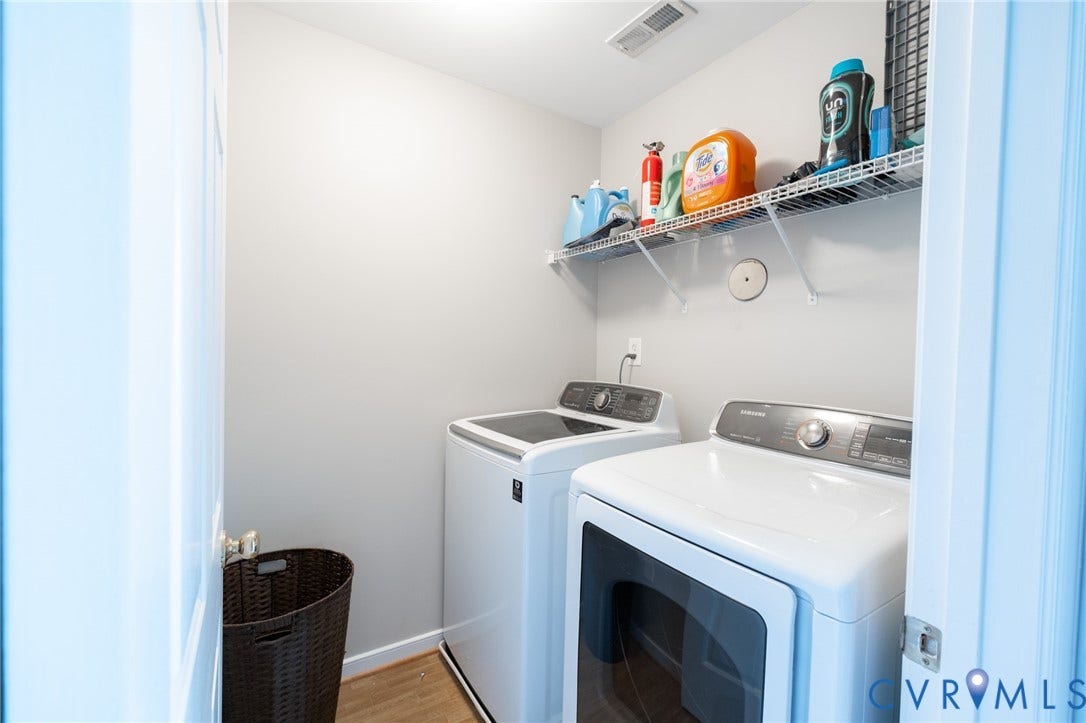 4805 Saddleridge Court, Saddleridge At Twin Hickory, Glen Allen, VA 23059 Dedicated 2nd floor laundry area featuring a white front-load washing machine, a white top-load washing machine, and overhead wire shelving for storage
