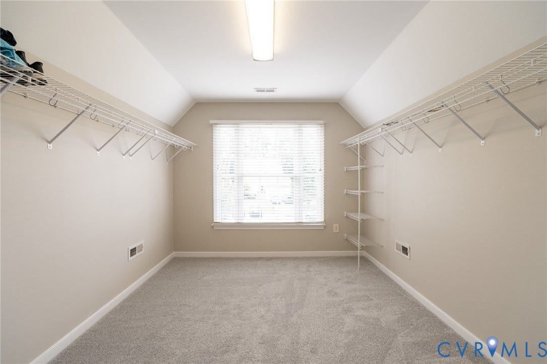 4805 Saddleridge Court, Saddleridge At Twin Hickory, Glen Allen, VA 23059 Primary bedroom closet featuring vaulted ceilings, light gray carpet flooring, and a large window with blinds