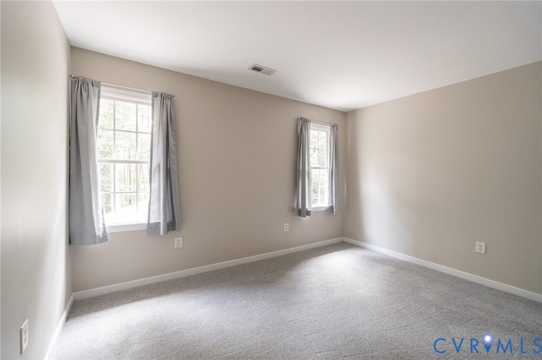 4805 Saddleridge Court, Saddleridge At Twin Hickory, Glen Allen, VA 23059 Neutral-toned room featuring two windows, light gray walls, and gray carpet flooring