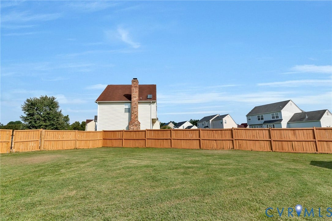 1601 Varina Station Court, Henrico, VA 23231 Expansive green space featuring a wood privacy fence