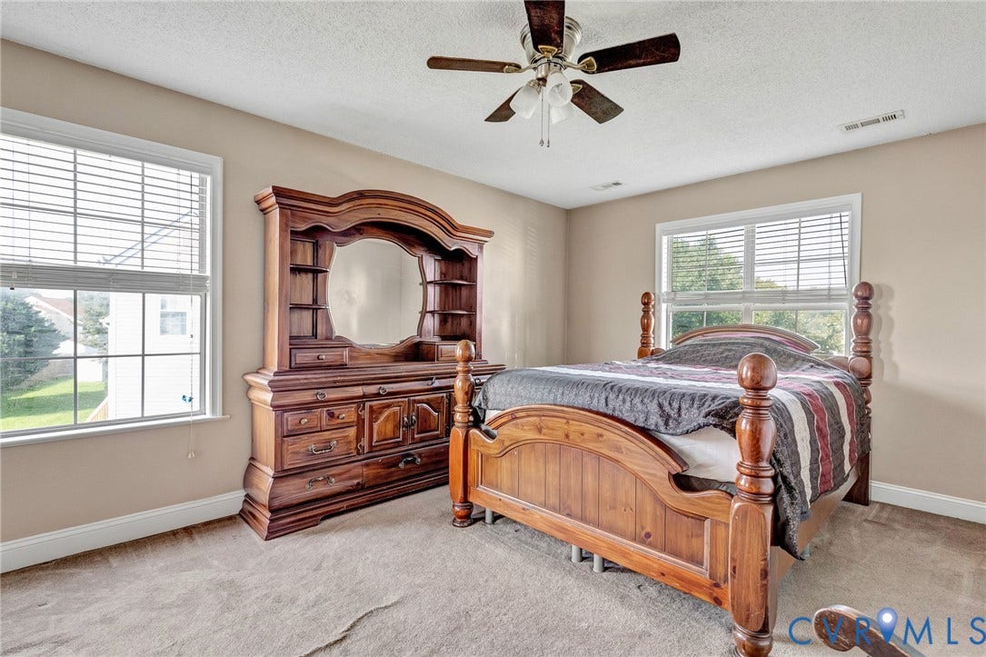 1601 Varina Station Court, Henrico, VA 23231 Neutral-toned walls, two windows with blinds, a ceiling fan with light fixture, and carpeted flooring