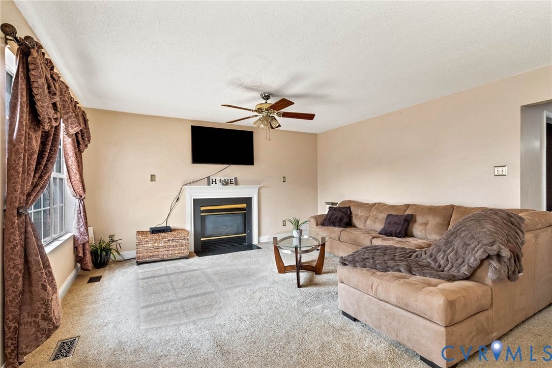 1601 Varina Station Court, Henrico, VA 23231 Wall-mounted television with a white mantel and a dark fireplace insert