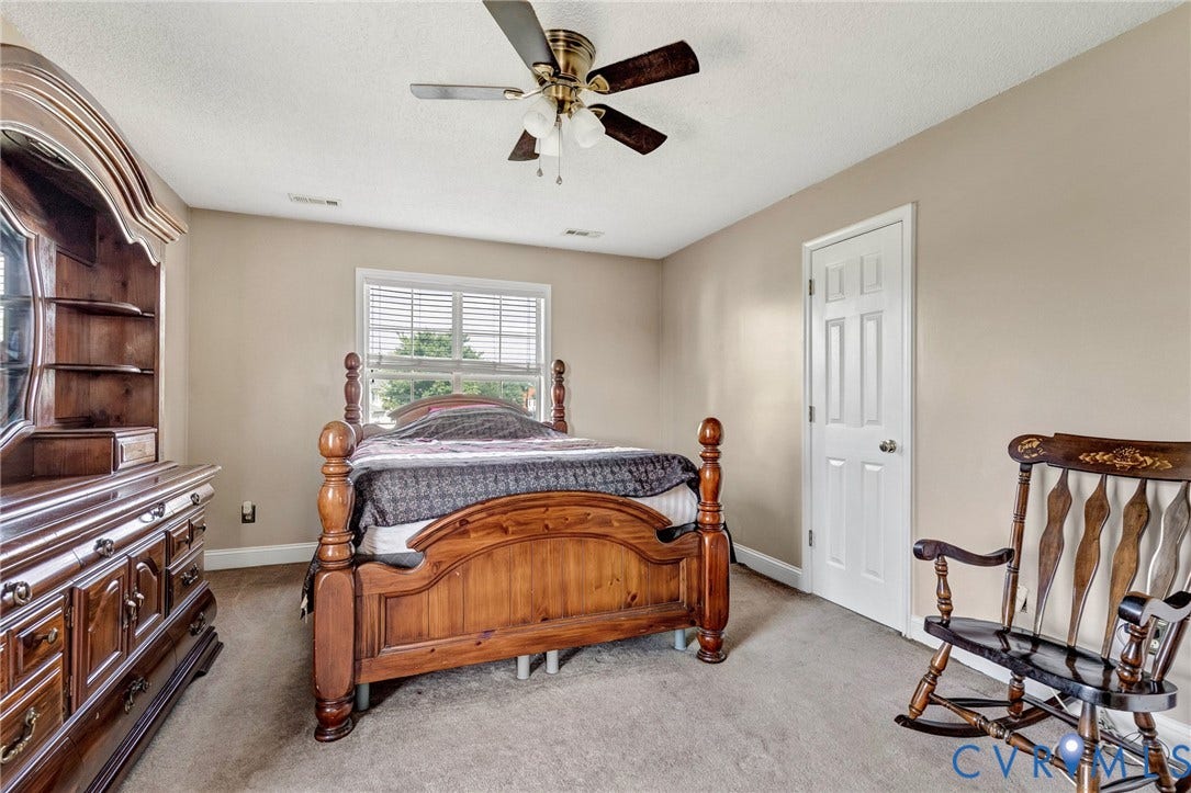 1601 Varina Station Court, Henrico, VA 23231 Carpeted room with a ceiling fan, a window with blinds, and a paneled door